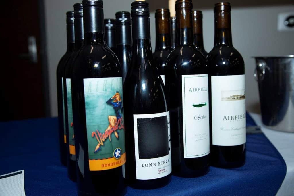 A collection of wine bottles displayed on a table, perfect for Gulf Coast gatherings. Enjoy premium wines in a scenic Gulf Coast setting for memorable celebrations and events.